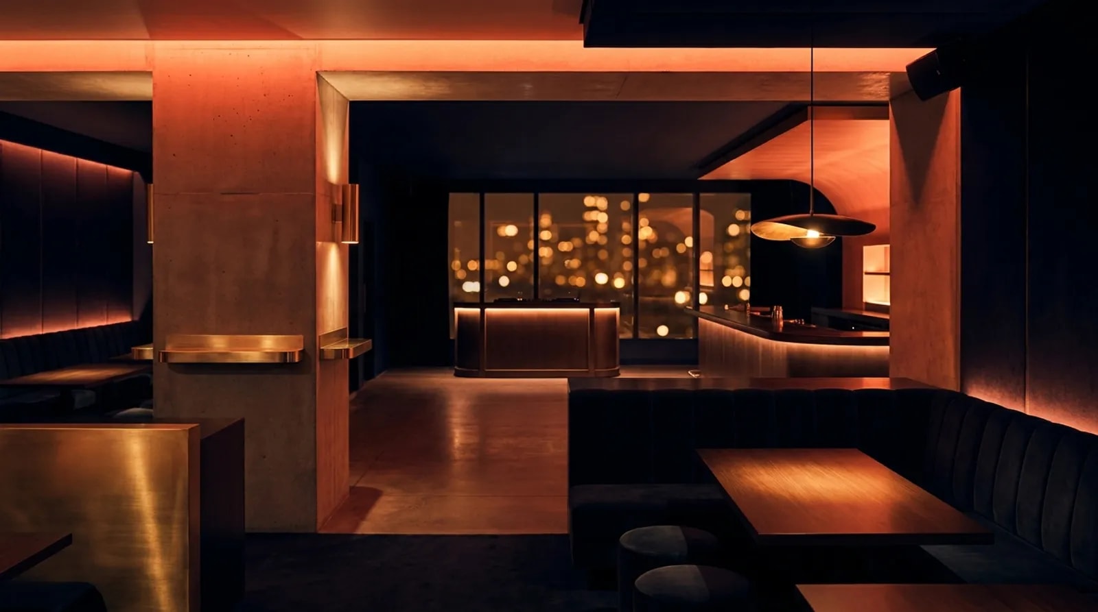 An upscale nightclub interior washed in warm light, empty DJ booth and bar before the doors open