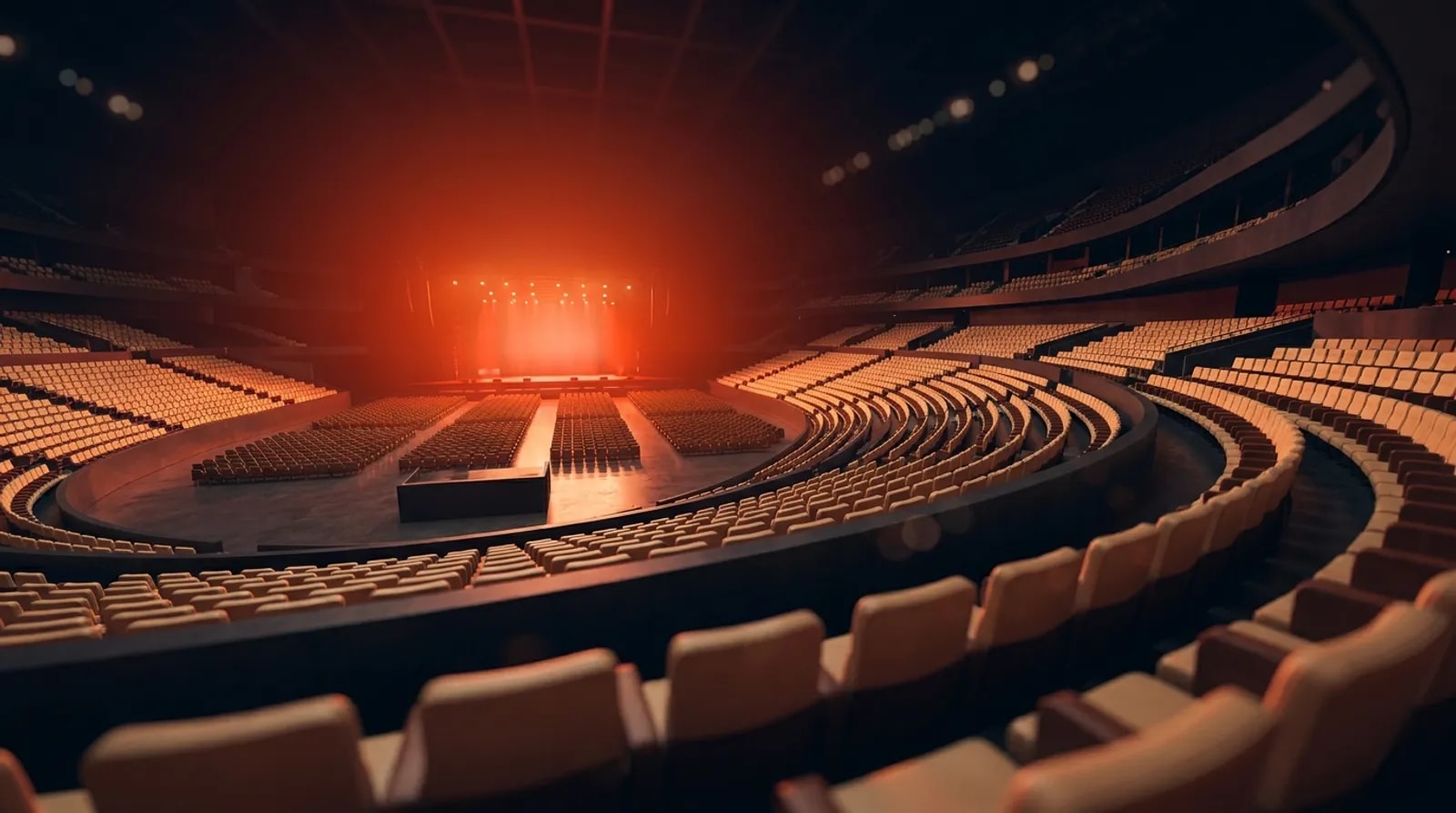 A modern arena glowing with warm light before an event, tiers of empty seats waiting to fill